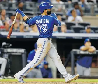  ?? JIM MCISAAC / GETTY IMAGES ?? Jose Bautista of the Blue Jays follows through on his 10th- inning home run against the Yankees on Friday in New York City.