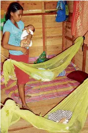  ?? NICO ALCONABA ?? ANNALIZA Leban and her triplets, the first beneficiar­ies of the Catholic Relief Services shelter project