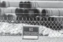  ?? Chris Machian / Associated Press ?? Pipes to be used for the Keystone XL pipeline are stored late last year in a field near Dorchester, Neb. Attorney General Ken Paxton is leading a lawsuit over the pipeline’s permit revocation.