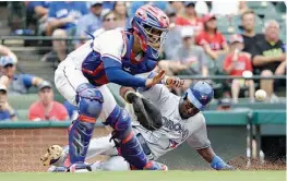  ?? AP Photo/Tony Gutierrez ?? Texas Rangers catcher Robinson Chirinos reaches for the throw as Toronto Blue Jays' Dwight Smith scores on a double by Luke Maile in the fifth inning Thursday in Arlington, Texas.