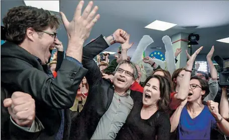  ?? Tobias Schwarz AFP/Getty Images ?? GREENS PARTY candidate Svien Gielgold, center, and co-leader Annalena Baerbock celebrate last month’s EU parliament election.