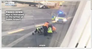  ??  ?? PINNED DOWN Man is restrained on the tarmac at Dublin Airport