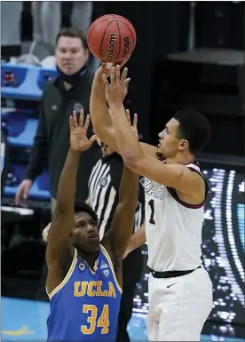  ?? DARRON CUMMINGS — THE ASSOCIATED PRESS ?? Gonzaga guard Jalen Suggs (1) shoots over UCLA guard David Singleton (34) to win the game during overtime in a men’s Final Four NCAA college basketball tournament semifinal game, Saturday, April 3, 2021, at Lucas Oil Stadium in Indianapol­is. Gonzaga won 93-90.