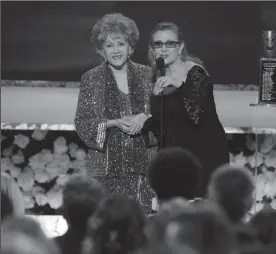  ?? ROBERT GAUTHIER/LOS ANGELES TIMES ?? Carrie Fisher presents the Life Achievemen­t Award to Debbie Reynolds at the 21st Annual Screen Actors Guild Awards on Jan. 25, 2015, at the Shrine Auditorium in Los Angeles.