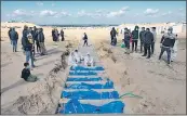  ?? EFE ?? Trabajador­es del Ministerio de Sanidad palestino preparan los cuerpos para un entierro masivo en el campo de Rafah, al sur de la Franja de Gaza.