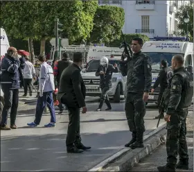 ?? AP PHOTO/RIADH DRIDI ?? Tunisian police officers secure the site of an attack after a 30-year-old woman blew herself up on the Habib Bourguiba avenue in Tunis, Tunisia, on Monday.