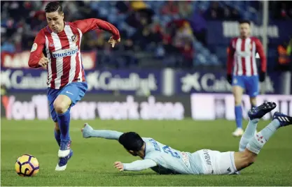  ??  ?? MADRID: Atletico Madrid’s forward Fernando Torres (L) runs with the ball as Celta Vigo’s Argentinia­n defender Facundo Roncaglia falls down during the Spanish league football match Club Atletico de Madrid vs RC Celta de Vigo at the Vicente Calderon...