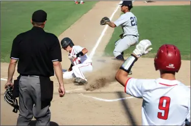  ?? MIKE BUSH/NEWS-SENTINEL ?? Lodi runner Angelo Zazzarino slides safely into home plate in the bottom of the first inning of Thursday's TCAL baseball game against West at Zupo Field, while Tracy's Alex Crisp (20) who is awaiting the throw.