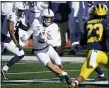  ?? CARLOS OSORIO — THE ASSOCIATED PRESS ?? Penn State wide receiver Parker Washington (3) looks for running room as Michigan linebacker Michael Barrett (23) closes in during the first half of Friday’s game in Ann Arbor.