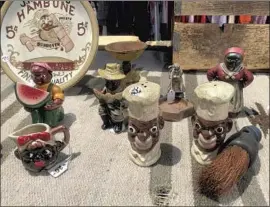  ?? Makeda Easter Los Angeles Times ?? AMONG the antiques for sale at the Rose Bowl Flea Market are racist, anti-Black memorabili­a. The event operator says a team conducts patrols to inspect items.