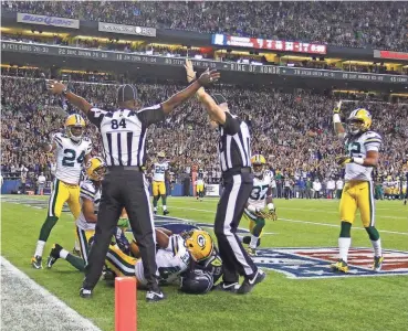  ?? RICK WOOD / MILWAUKEE JOURNAL SENTINEL ?? In what has become known as the “Fail Mary” game, officials indicate opposite rulings — one a touchdown, one incomplete — in the Green Bay Packers’ 14-12 loss to the Seattle Seahawks in Seattle in 2012.