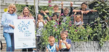  ?? FOTO: BORROMÄUM ?? Sie freuen sich über die insektenfr­eundliche Pracht in den Pflanzkübe­ln am Borromäum (von links): Eva Stengel, Annette Meidert, Vanessa Köder, Ansgar Baumann und die Kinder aus dem Hort.