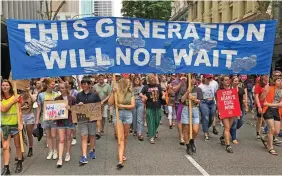  ??  ?? Student protestors leading the march against Adani’s Carmichael mine and rail project.