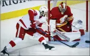  ?? JEFF MCINTOSH — THE CANADIAN PRESS VIA AP ?? Detroit Red Wings forward Michael Rasmussen, left, tries to score against Calgary Flames goalie Dan Vladar during the second-period of Thursday’s game in Calgary, Alberta.