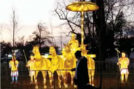  ?? — AP ?? A man pass past one of illuminate­d sculptures during a concert at Belgrade’s Kalemegdan Fortress, Serbia, on Saturday.