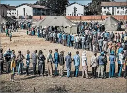  ?? LUIS TATO/GETTY-AFP ?? Voters wait to cast ballots Monday at a polling station near Harare, Zimbabwe.