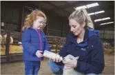  ??  ?? LEFT Singing in trios by week, herding on quads at the weekend, “…in my working gear with my hair up and no make-up” BELOW Gwawr’s daughter helps with an orphaned lamb