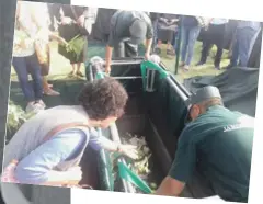  ??  ?? A picture of Fr. Salv (left) and a woman putting flowers on his grave