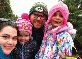  ?? Associated Press ?? Holly Nordenberg, left, poses with her family, Gia, 3, from second left, husband Ross and Gwen, 5, in Oregon, Wis. For some planning to stay home for Christmas, giving up the hassle and family drama of holiday travel isn’t such a bad deal in the end. Holly Nordenberg said her family will stay home and will focus on “gratitude and baking” at home.