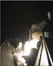  ?? MASS COMMUNICAT­ION SPECIALIST 3RD CLASS ROBERT S. PRICE — U.S. NAVY VIA AP ?? The USS Ross (DDG 71) fires a tomahawk land attack missile Friday from the Mediterran­ean Sea.