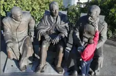  ?? Yuri Lashov/AFP/Getty Images/TNS ?? A sculptor assistant touches up a monument featuring Soviet leader Josef Stalin, right, President Franklin D. Roosevelt, center, and British Prime Minister Winston Churchill, the three Allied leaders, side by side in the Yalta conference in Crimea.