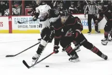  ?? KARL B DEBLAKER/AP ?? CAROLINA HURRICANES’ SEBASTIAN AHO (20) and Arizona Coyotes’ Phil Kessel (81) tussle during the third period of a game in Raleigh, N.C., Sunday.