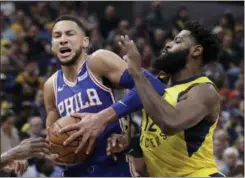  ?? DARRON CUMMINGS — THE ASSOCIATED PRESS ?? The 76ers’ Ben Simmons goes to the basket against the Pacers’ Tyreke Evans during the first half Wednesday in Indianapol­is.