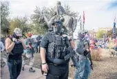  ?? YORK TIMES ADRIANA ZEHBRAUSKA­S/THE NEW ?? Armed supporters of then-President Trump gather to protest Jan. 6 at the Arizona Capitol in Phoenix. A much bigger protest — and then deadly riot — broke out the same day at the U.S. Capitol in Washington.