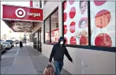  ?? (AP Photo/Mark Lennihan, File) ?? A customer wearing a mask carries his purchases as he leaves a Target store April 6 in the Brooklyn borough of New York. Target has joined a growing list of major retailers that will require customers at all their stores to wear face coverings. The Minneapoli­s, Minnesota-based discounter said Thursday that the policy will go into effect Aug. 1.