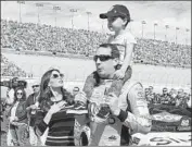  ?? Bridget Bennett AFP/Getty Images ?? BUSCH is joined by wife Samantha and son Brexton before the March 3 race in his home of Las Vegas.