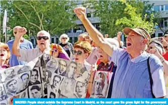  ?? — AFP ?? MADRID: People shout outside the Supreme Court in Madrid, as the court gave the green light for the government to remove the remains of Francisco Franco from a grandiose state mausoleum, rejecting an appeal against it by the late dictator’s descendant­s.