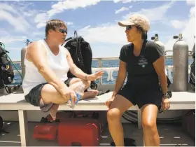  ?? Caleb Jones / Associated Press 2015 ?? Marine biologist Ruth Gates (left) and Malia Chow, superinten­dent of Hawaii’s Humpback Whale National Marine Sanctuary, discuss reefs off Oahu in 2015.