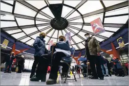  ?? PAUL CHIASSON — THE CANADIAN PRESS ?? People wait in line for a COVID-19 vaccine at a clinic at Olympic Stadium in Montreal on Monday.