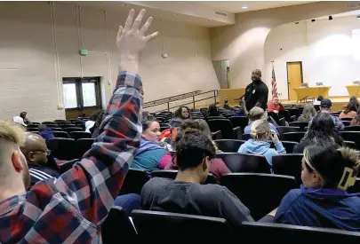  ?? The Sentinel-Record/Donald Cross ?? Hananiah Moore, the father of a first-grade student at Park Magnet, an IB World School, raises his hand to ask Hot Springs School District Police Chief Carl Seymour a question, during executive session of Tuesday night’s regular monthly Hot Springs School Board meeting at Roy Rowe Auditorium.