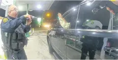  ?? REUTERS ?? Lieutenant Caron Nazario raises his hands at a gas station during a violent traffic stop by Windsor police officers Joe Gutierrez, left, and Daniel Crocker.