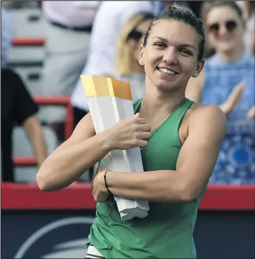  ?? GETTY IMAGES ?? Simona Halep of Romania hugs the trophy during the post-game ceremony after defeating Sloane Stephens 7-6, 3-6, 6-4 at the Rogers Cup yesterday.