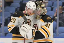  ?? AP PHOTO ?? JOB WELL DONE: Bruins forward Joakim Nordstrom (20) and goalie Jaroslav Halak celebrate their 4-0 victory over the Sabres last night in Buffalo.