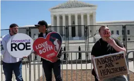  ?? Photograph: Leah Millis/Reuters ?? Mark Lee Dickson, left, holds an anti-abortion signs outside of the supreme court, on 9 May 2022.