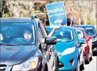  ?? Dan Haar / Hearst Connecticu­t Media ?? More than 50 cars gather in front of the governor’s Executive Residence in Hartford earlier this year. Advocates are calling on the state to begin commuting prison sentences again.