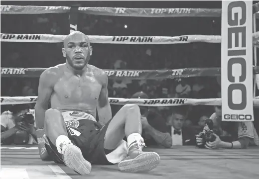  ?? CHRISTIAN PETERSEN/GETTY IMAGES ?? Raymundo Beltran reacts after a knockdown Saturday at Gila River Arena in Glendale.