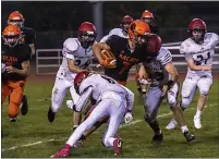  ?? ?? Arcata High’s Carson Tucker is tackled hard by McKinleyvi­lle High’s Willie Baumgarten, but not after making another first down for the Arcata Tigers.