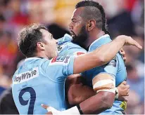  ??  ?? Hug: Taqele Naiyaravor­o celebrates a try for Waratahs