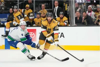  ?? (AP Photo/lucas Peltier) ?? Vegas Golden Knights defenseman Noah Hanifin (15) passes the puck against Vancouver Canucks right wing Brock Boeser (6) Thursday during the first period of an NHL hockey game in Las Vegas.