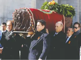  ?? JUAN CARLOS HIDALGO / POOL VIA REUTERS ?? Late Spanish dictator Francisco Franco’s relatives carry his coffin out of the Basilica of The Valley of the Fallen Thursday, to be moved to a private grave.