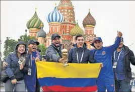  ?? AFP ?? Colombian fans with a trophy replica in front of Saint Basil's Cathedral on the Red Square, Moscow.