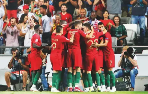  ?? AP ?? Portugal players celebrate after Andre Silva scored the opening goal during the Uefa Nations League match against Italy at the Luz stadium in Lisbon on Monday. The hosts won the clash 1-0.