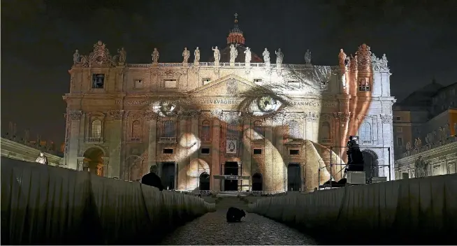  ?? PHOTO: REUTERS ?? A picture by US photograph­er Steve McCurry is used in an art projection featuring images of humanity and climate change on the facade of St Peter’s Basilica at the Vatican.