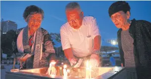  ?? PHOTOS BY EPA ?? Relatives offer prayers for victims of the Aug 6, 1945 atomic bombing at Hiroshima Peace Memorial Park yesterday.