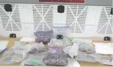  ??  ?? Calgary police display some of the nearly $1 million worth of illegal drugs and production parapherna­lia seized after a month-long investigat­ion.