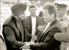  ?? PTI ?? ▪ Pakistan's PM Imran Khan shakes hands with cricketert­urnedpolit­ician, Navjot Singh Sidhu, during the ground breaking ceremony for the Kartarpur corridor, November 28